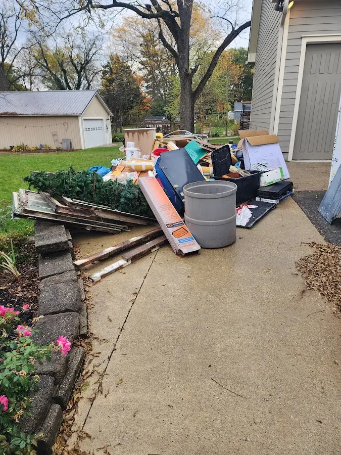 Dumpster being loaded with debris for Estate Cleanout Dumpster Rental in East Flat Rock